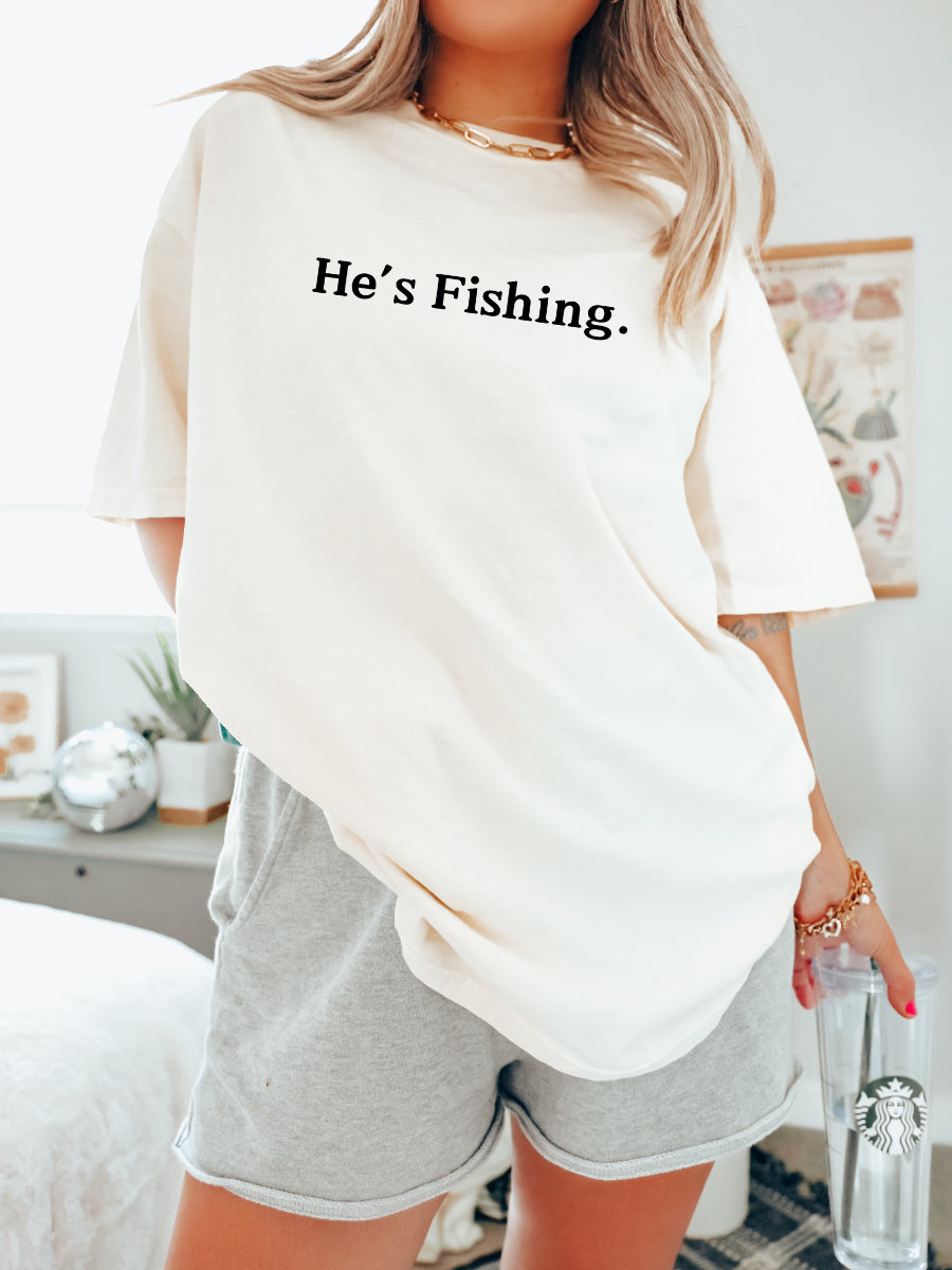 HE'S FISHING. - ADULT TEE