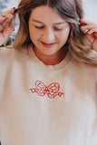 EMBROIDERED CHRISTMAS BOW TAN CORDED CREW