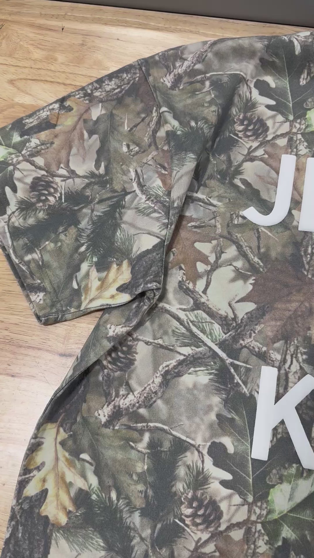 Load video: JESUS IS KING PUFF VINTAGE CAMO TEE